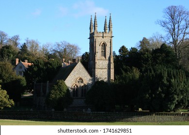 Rural English village church. Image with blue sky and clouds
