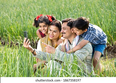 Rural Family Taking Selfie Using Mobile Phone On Agriculture Field