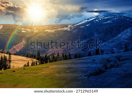 rural fields on the hill on spring equinox. day and night time change concept. snow capped mountain in the distance with sun and moon. beautiful landscape with clouds. duality and transition template