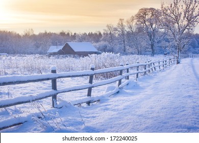 Rural House With A Fence In Winter