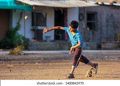 Rural Indian Child Playing Cricket