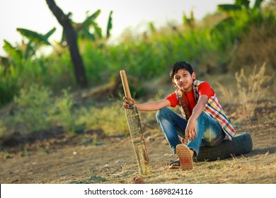 Rural Indian Child Playing Cricket