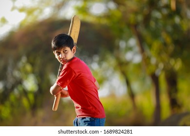 Rural Indian Child Playing Cricket