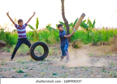 Rural Indian Child Playing Cricket