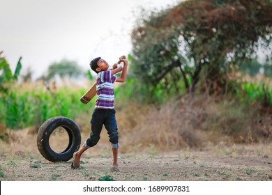 Rural Indian Child Playing Cricket