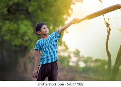 Rural Indian Child Playing Cricket