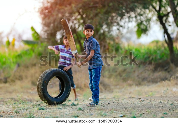 Rural Indian Child Playing Cricket Stock Photo (Edit Now) 1689900334