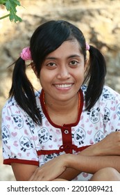 Rural Indonesian Woman Two Braids Smiling Looking At The Camera