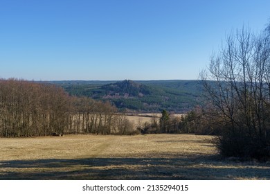 Rural Landscape In Bohemia With Meadows, Fields And Forests In March At The End Of Winter In Sunny Weather