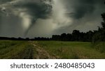 Rural landscape of Po Valley countryside with a dramatic tornado in the background, capturing nature