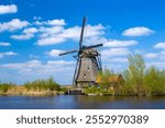 rural landscape with windmills at famous tourist site Kinderdijk in Netherlands. This system of 19 windmills was built around 1740 and is a UNESCO heritage site