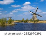 rural landscape with windmills at famous tourist site Kinderdijk in Netherlands. This system of 19 windmills was built around 1740 and is a UNESCO heritage site