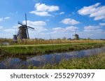 rural landscape with windmills at famous tourist site Kinderdijk in Netherlands. This system of 19 windmills was built around 1740 and is a UNESCO heritage site