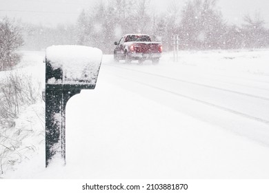 Rural Mailbox And Road During Winter Blizzard