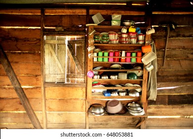 A Rural Makeshift Kitchen In Central America With Pots And Pans And Jars On A Shelf Made With Wood