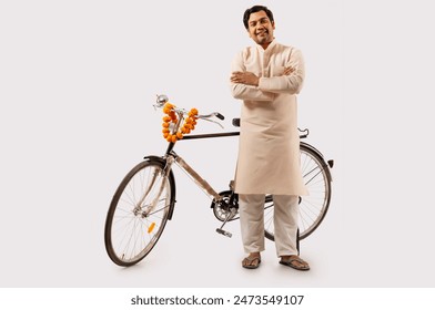 A RURAL MAN CONFIDENTLY POSING WHILE STANDING WITH NEW BICYCLE - Powered by Shutterstock