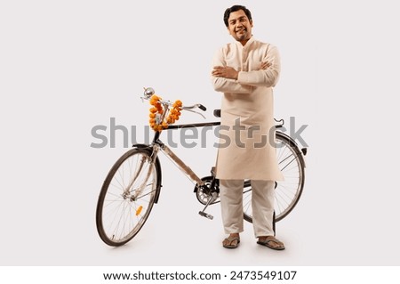 A RURAL MAN CONFIDENTLY POSING WHILE STANDING WITH NEW BICYCLE
