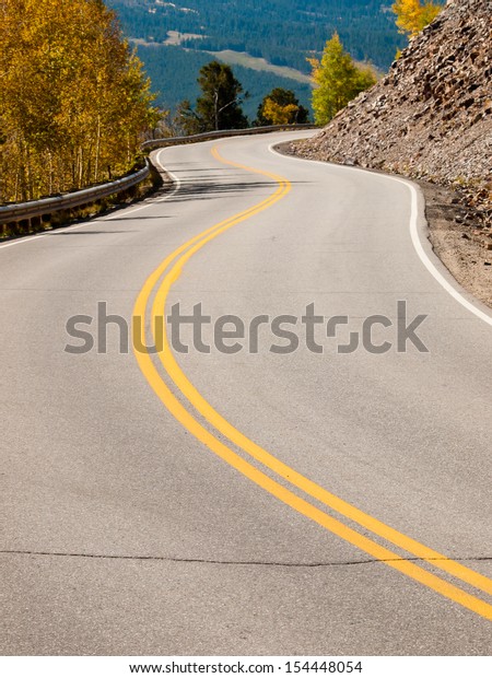 A rural mountain road with a winding \