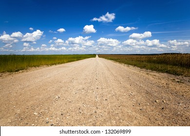   the rural not asphalted road passing through an agricultural field - Shutterstock ID 132069899