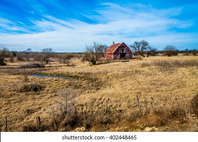 Rural Oklahoma Farmland With Abandoned Red Barn Or Farm House Isolated In A Large Field.