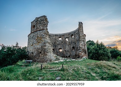 Rural old windmill Pricovy built in 18th century,beautiful and large Dutch-type mill in Czech Republic.Technical monument in Czech countryside.Ruins of stone house at sunset.Tranquil summer atmosphere