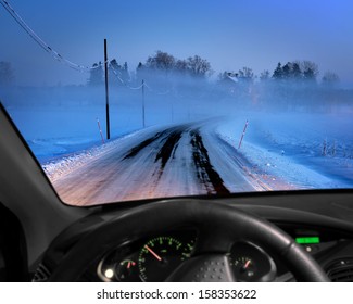 Rural Road In Cold Foggy Winter Evening Seen Through Windscreen Of Car