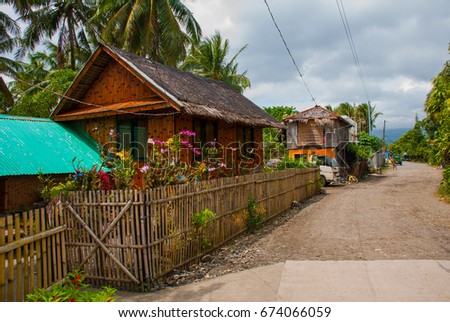 Rural road with houses in the Philippines. Pandan, Panay island