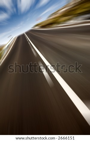 rural road on an angle with a blue sky in motion
