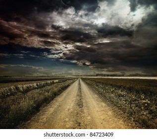 Rural Road Through A Field At Night