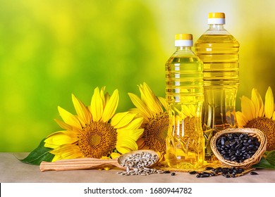 Rural still-life - sunflower oil in bottles with flowers of sunflower (Helianthus annuus), closeup