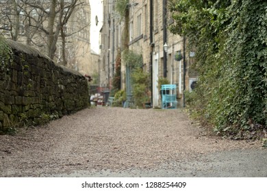 Rural Street In Country Village With Houses And Hedges