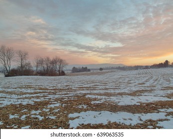 Rural Sunset Over Snowy Field