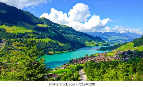Rural Swiss Scenery from Train Ride Window View, Picturesque Lungern Village and Lake Picture as a Painting in beautiful summer, Lungern, Switzerland, Europe. Travel Swiss Nature, Tourist Attraction.