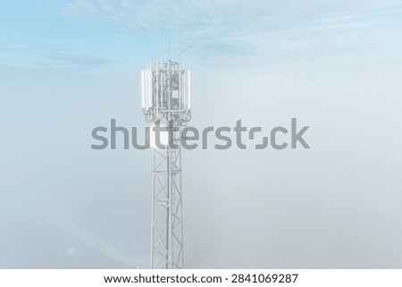 Rural telecom tower surrounded by fog and cold air