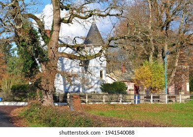 Rural View Of Old 1920s House With Conical Tower Beside Grassy Field With Autumnal Trees 