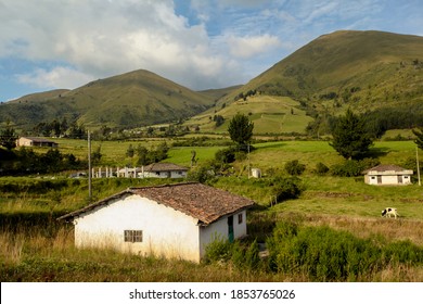 A rural village town tucked within green hills and a blue sky - Powered by Shutterstock