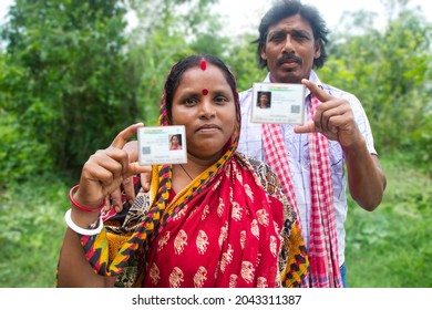 Rural Villager Couple Showing Aadhaar Card in agricultural field