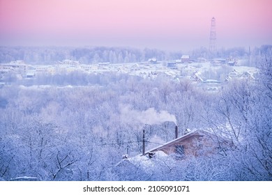 Rural Winter Hilly Landscape. Roofs Of The Houses Are Covered With Snow. A Cell Tower Is On Horizon.