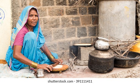 Rural women cooking front of her house, rural village Salunkwadi, Ambajogai, Beed, Maharashtra, India