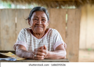 Rurrenabaque, Beni / Bolivia - May 13 2016: Old Wise Looking Indigenous Woman In White Dress Smiles At The Camera