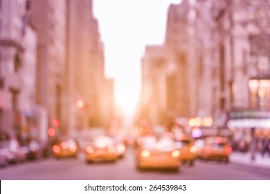 Rush hour with defocused yellow taxi cabs and traffic jam on 5th avenue in Manhattan downtown at sunset - Blurred bokeh postcard of New York City on a vintage marsala color filtered look - Powered by Shutterstock