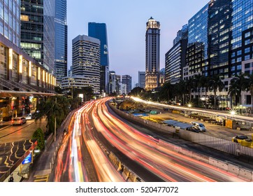 Rush hour traffic in Jakarta business district along the city main avenue, Jalan Sudirman, at night in Indonesia capital city