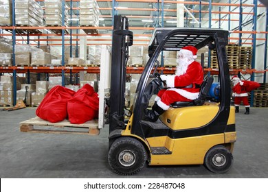 Rush Hours Before Christmas.Santa Claus As A Forklift Operator At Work In Warehouse