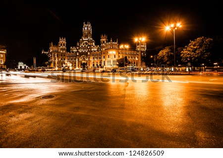 Rush of night time traffic at plaza de cibeles, madrid, spain ( HDR image )