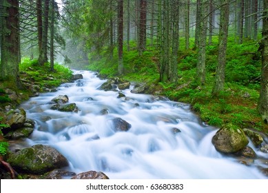 rushing blue river in a mountain forest - Powered by Shutterstock