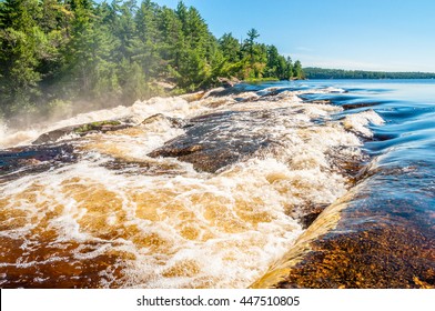 Rushing white water flows rapidly down Curtain Falls in a remote area of Minnesota known as the Boundary Waters Canoe area, bordering Quetico National Park in Canada. 