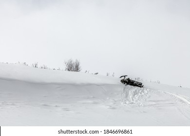 Russia, Adygea, February 21, 2013: Snowmobile Got Stuck In Deep Loose Snow On A Mountainside. Adygea, Russia.