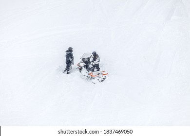 Russia, Adygea, Lago Naki, February 21, 2013: BRP Snowmobile Stuck In Deep Snow On A Mountainside.