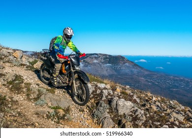 Russia, Alushta - October 1 2016: Motorcyclist rides down the mountain Chater-Dag, Crimea