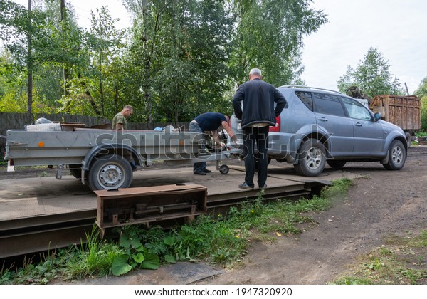 Russia - August 27, 2020. Kuvshinovo, Tver region,\
Russia. At the scrap metal collection point, a car trailer with\
metal stands on a scale.\
